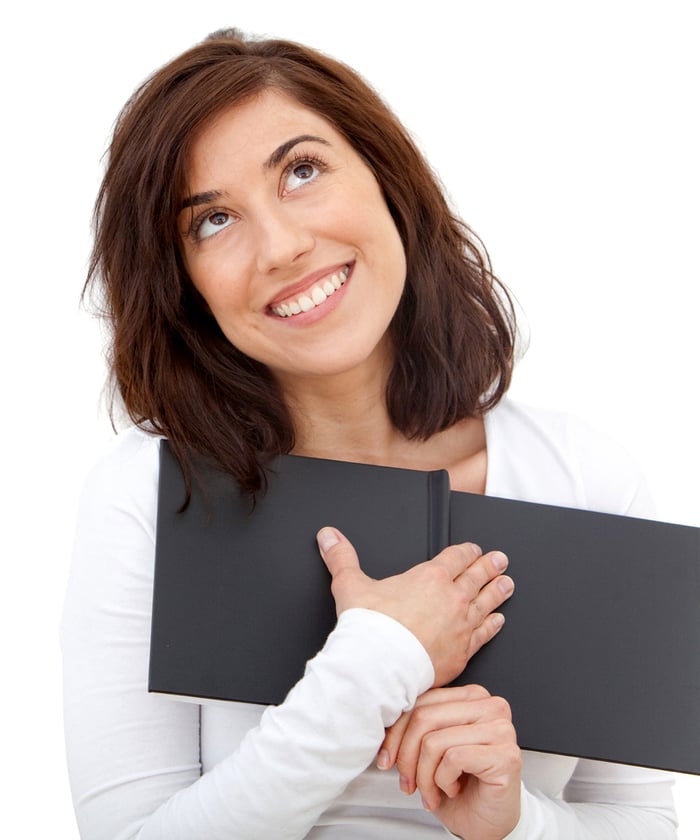 Happy woman reading romantic stories over a white background